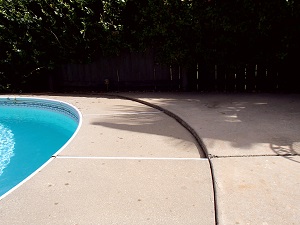 Before photo of sinking concrete pool deck